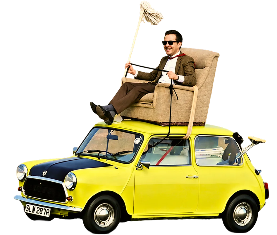 Old man in goggles riding a toy car